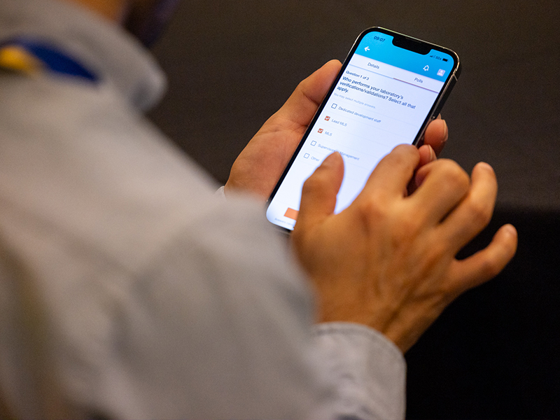 Man looking at ASCP Annual Meeting app on his phone